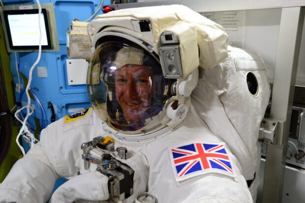 Tim trying on his spacesuit, preparing for EVA. Credit ESA/NASA