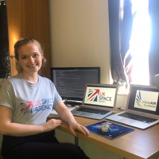 Ellie at her desk working on code 