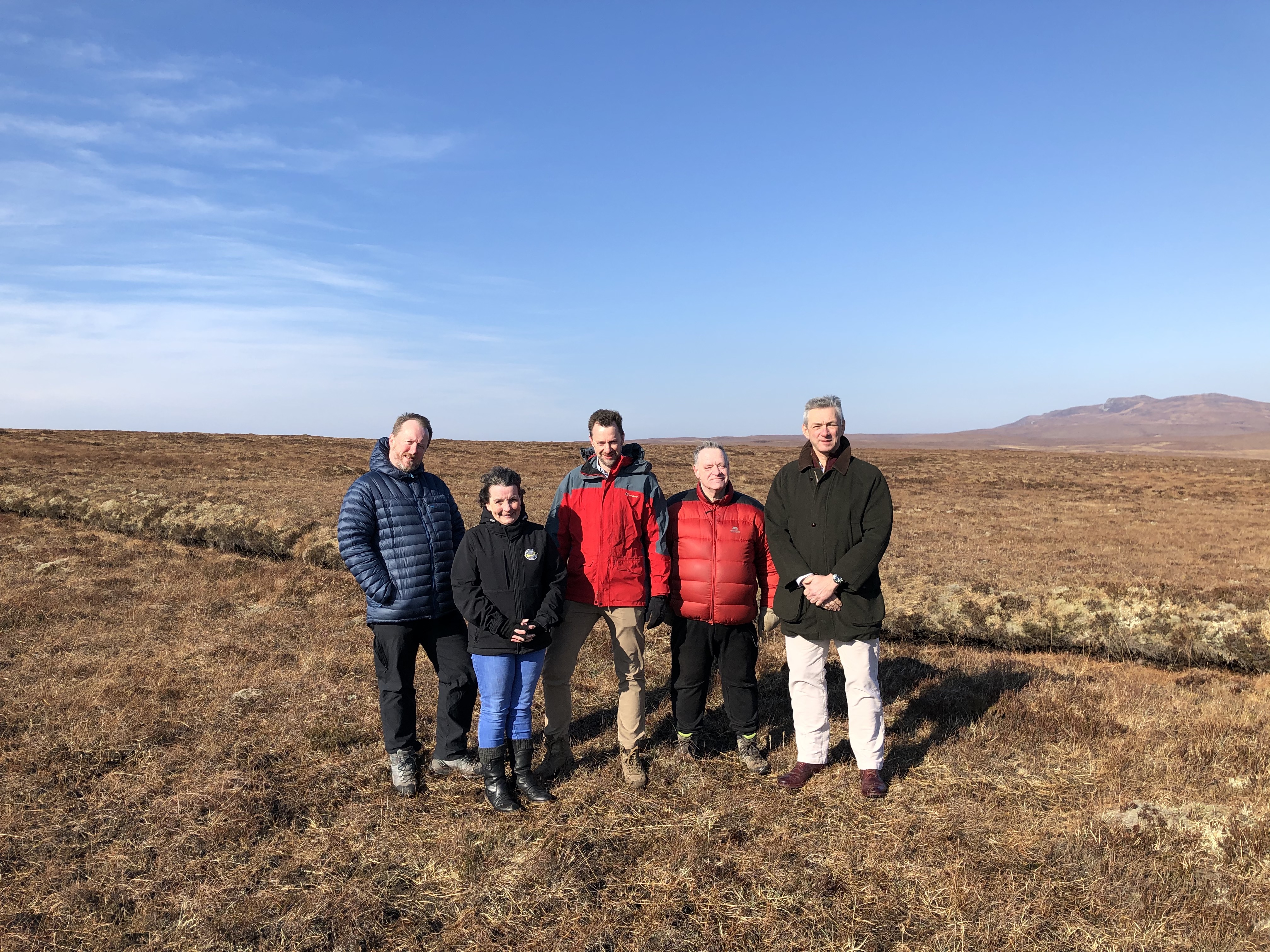 People stood in group looking at camera in Scotland countryside