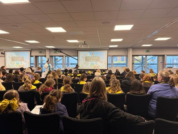 Brownies attend a rocket building workshop.
